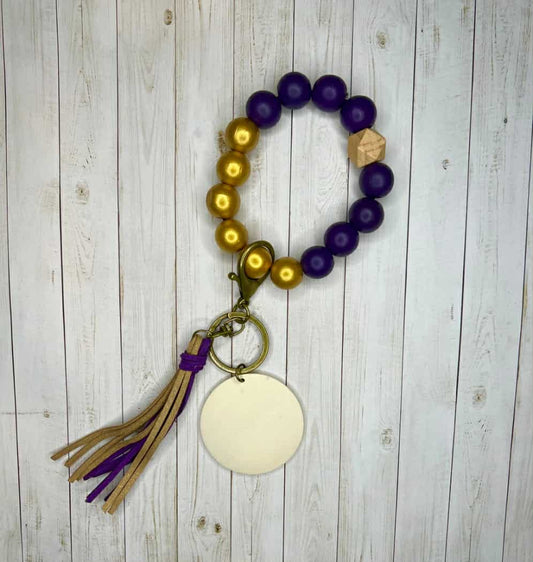 Purple and gold wristlet